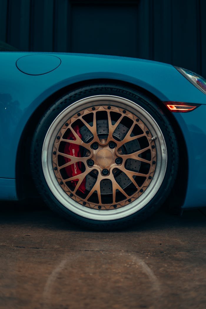 Elegant car wheel close-up featuring intricate alloy rims and sleek design.