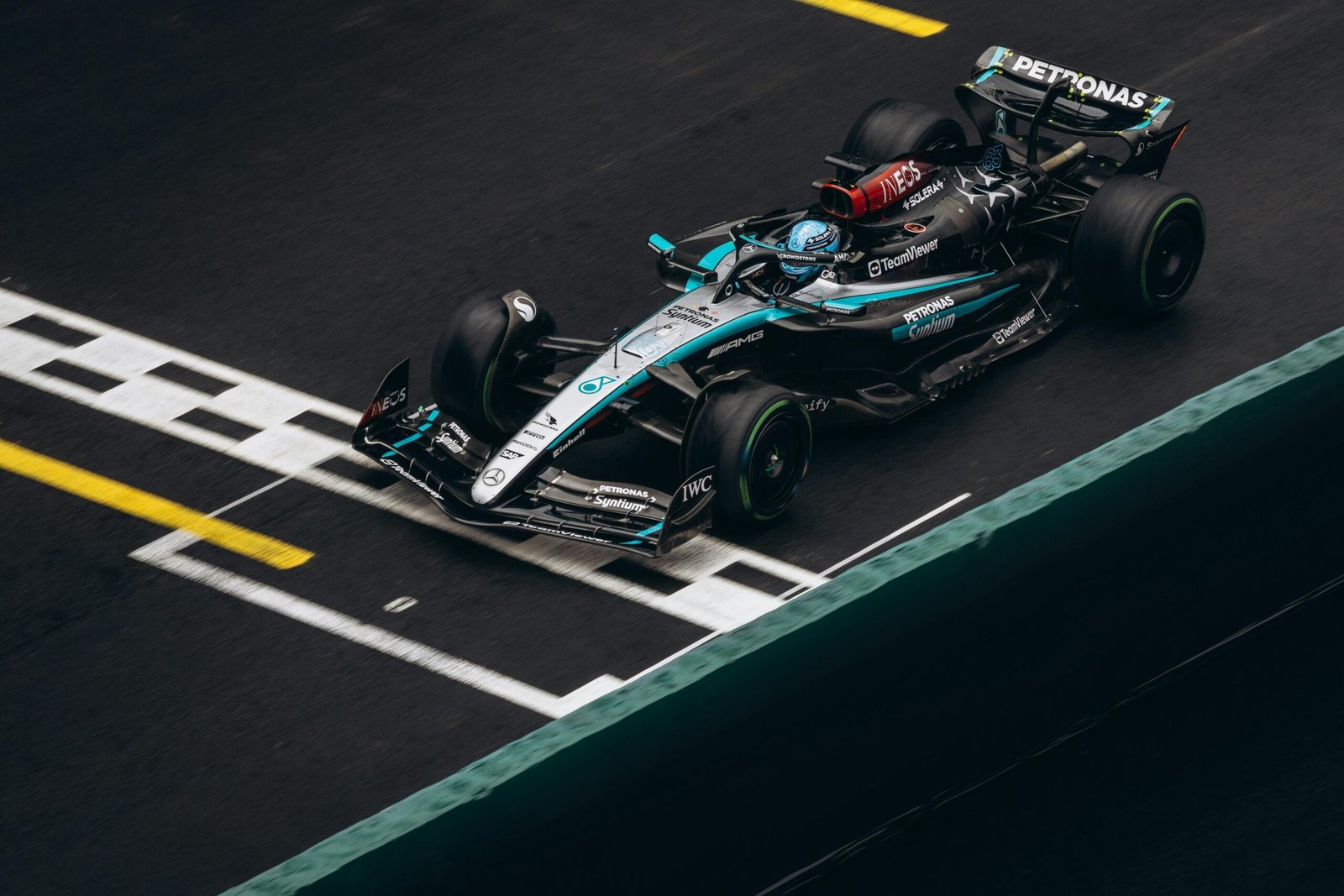 Top view of a Formula One car crossing the finish line in a high-speed race.